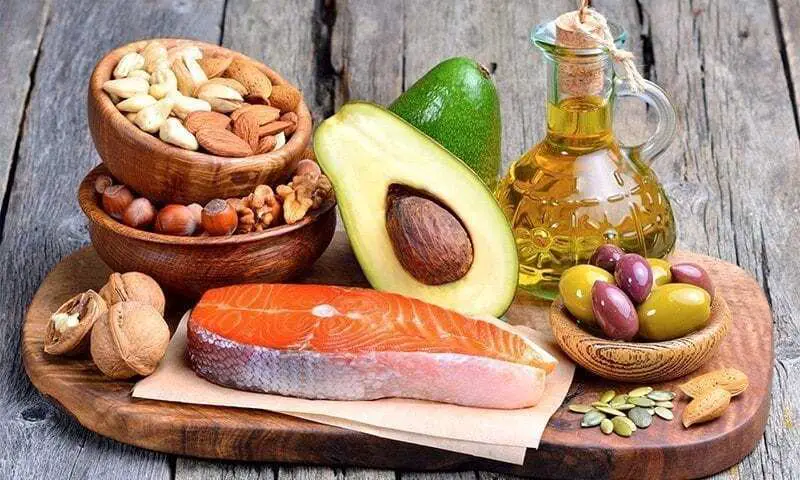healthy fats to eat picture with avocados, fish, nuts, olive oll