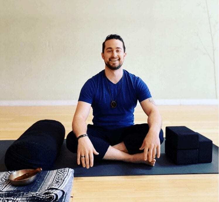 jared yoga headshot seated meditation smiling