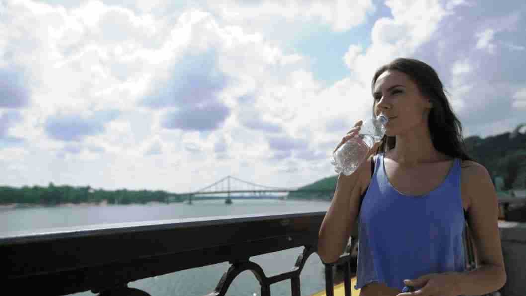 sipping on water bottle woman